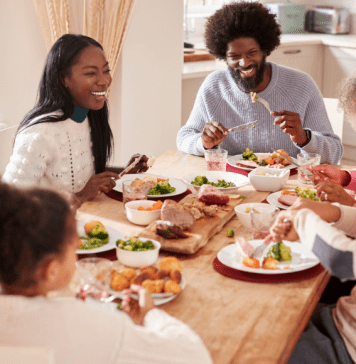 Black, multi-generational family eating dinner together